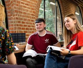 Students in library engaged in a discussion